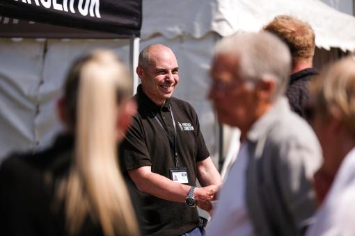Fundraiser smiling and shaking hands with a supporter